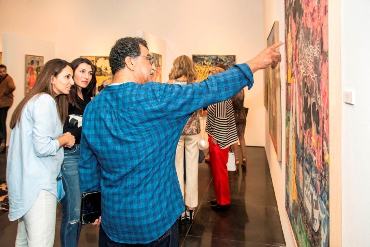 Mohamed Abla explains one of his paintings to the audience