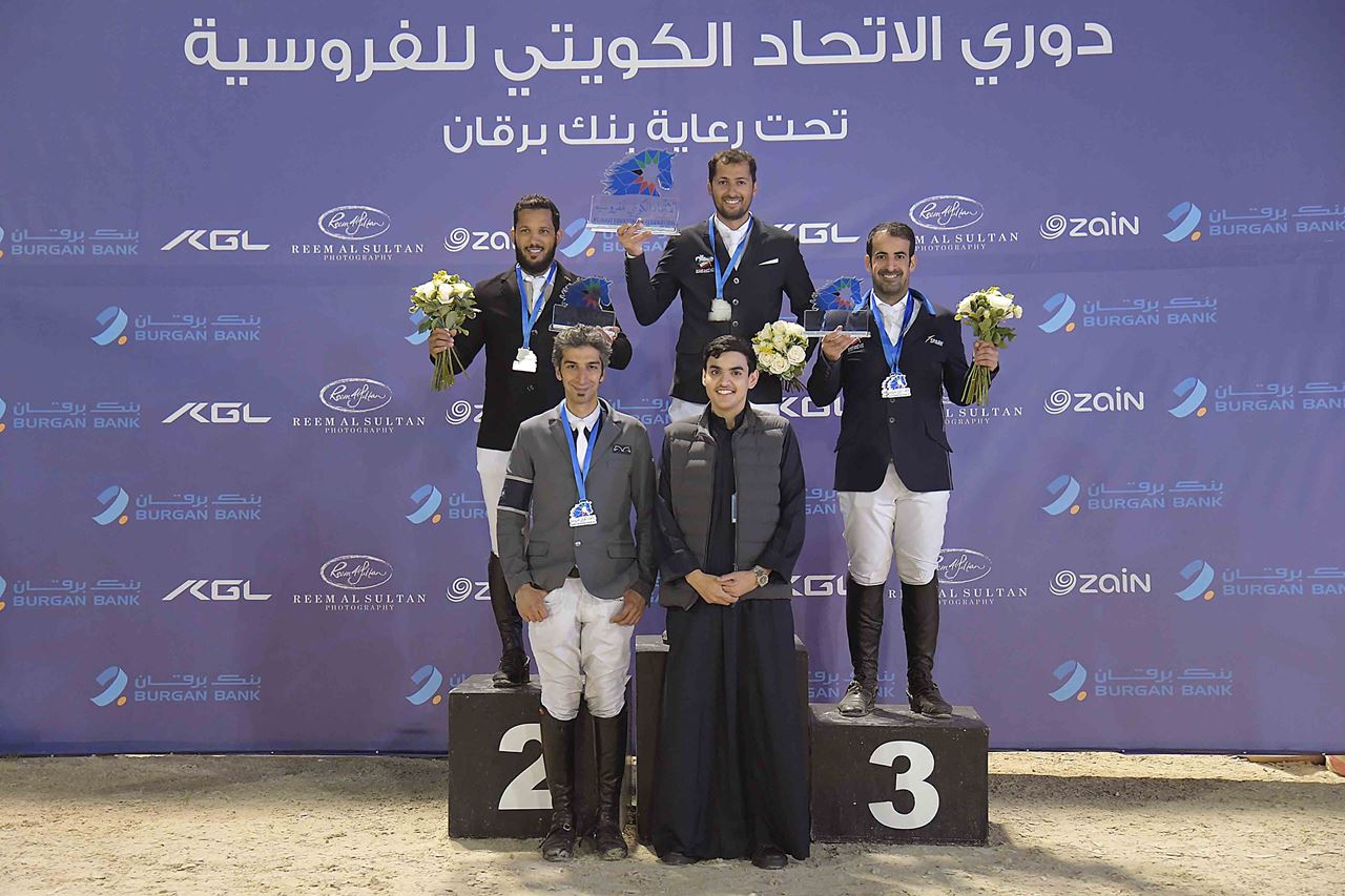 Mr. Talal AlAyar, Public Relations Officer at Burgan Bank, in a group photo with the winning equestrians 